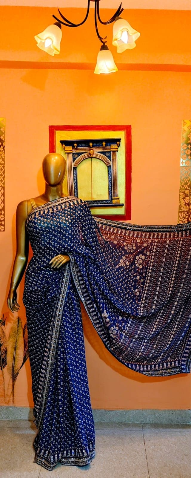 Indigo saree with an embroidered pallu, on a stand