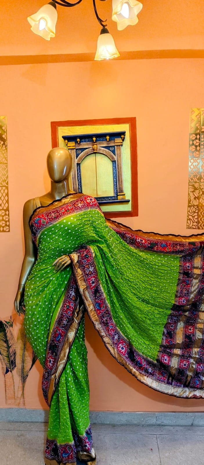 Draped pallu of the parrot-green saree