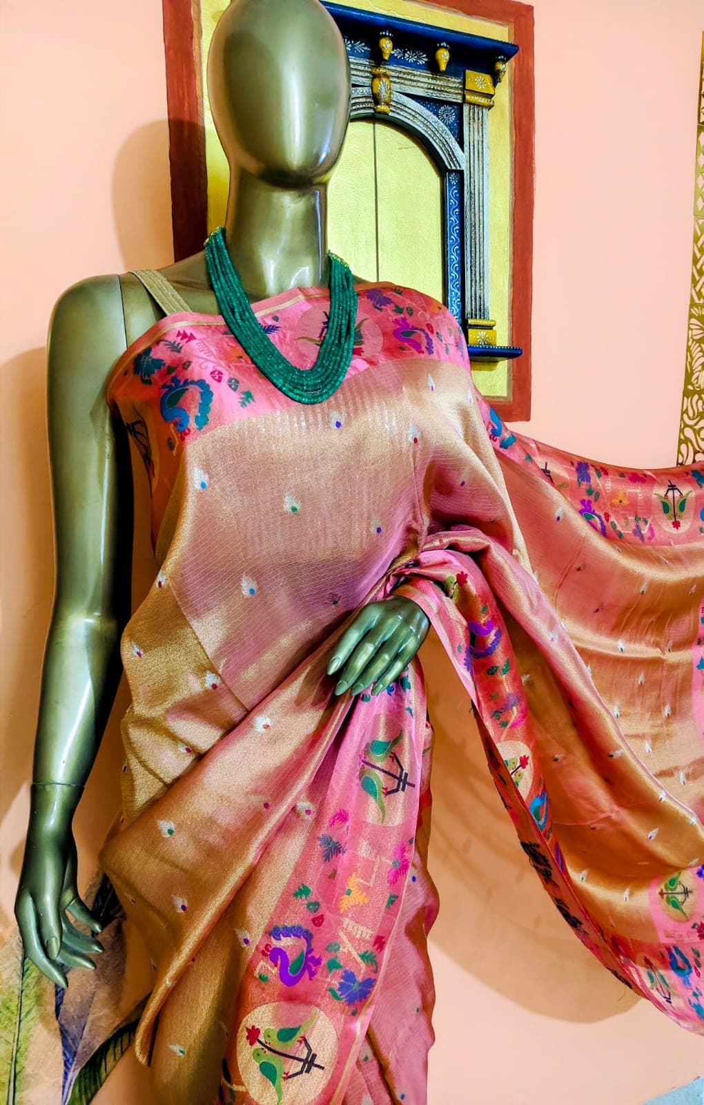 Shoulder drape and border of the coral saree