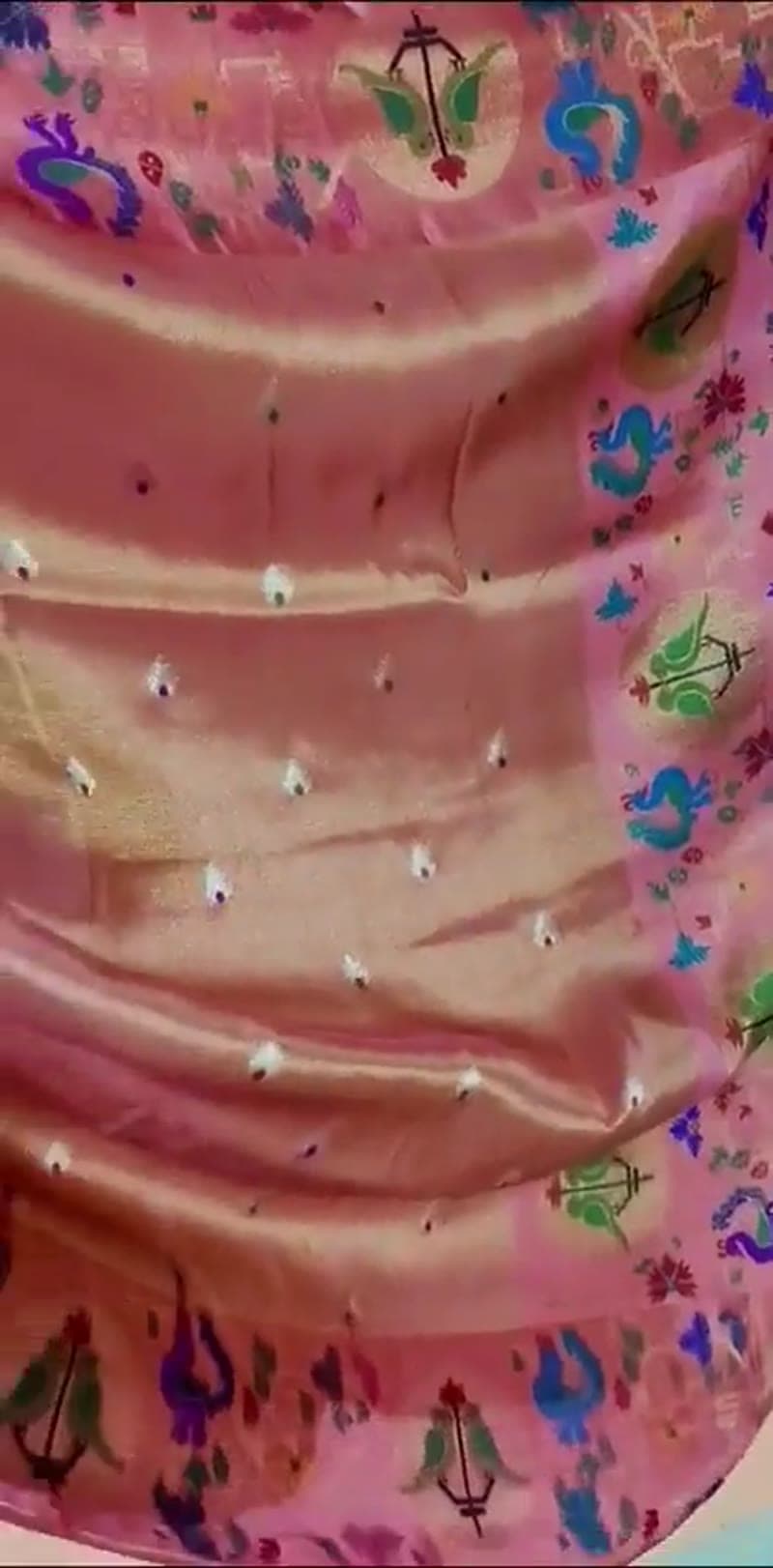 The coral saree shown in motion