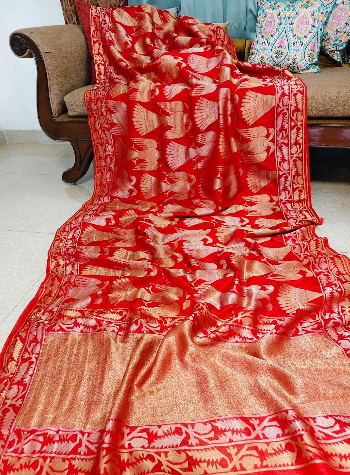 Flat-lay of the red bird-motif saree