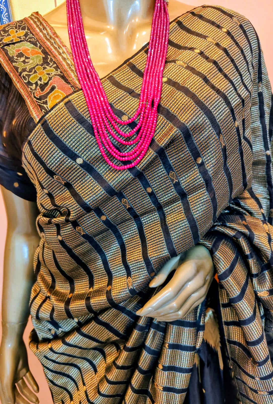Black and gold saree with a wave-striped weave and a floral temple-border blouse piece