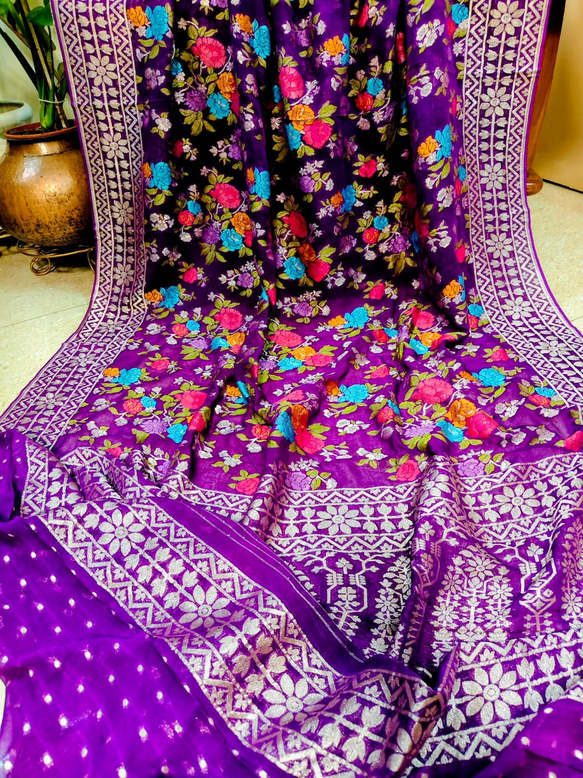 Purple floral Khaddi Georgette saree draped on a stand